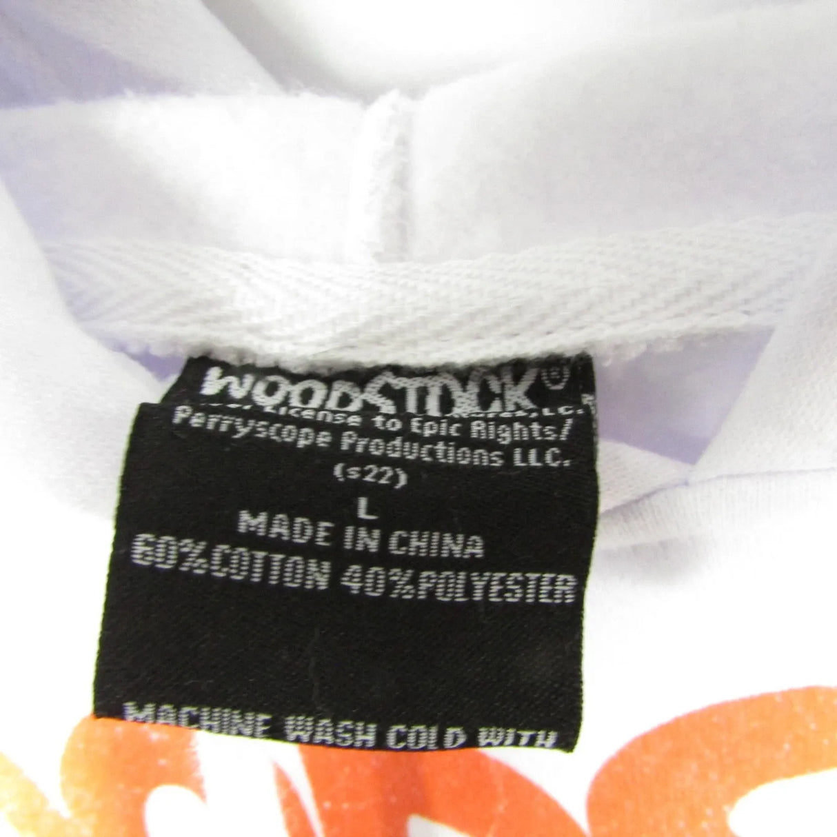 Clothing label with 'Woodstock' branding and fabric composition details on a white background.